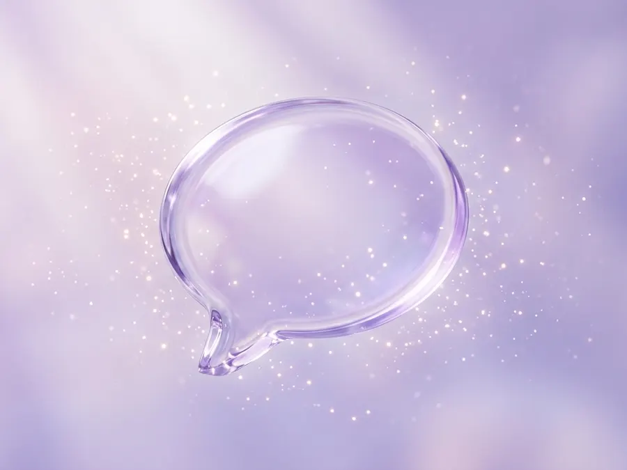 A glass chat bubble floating among soft sparkles